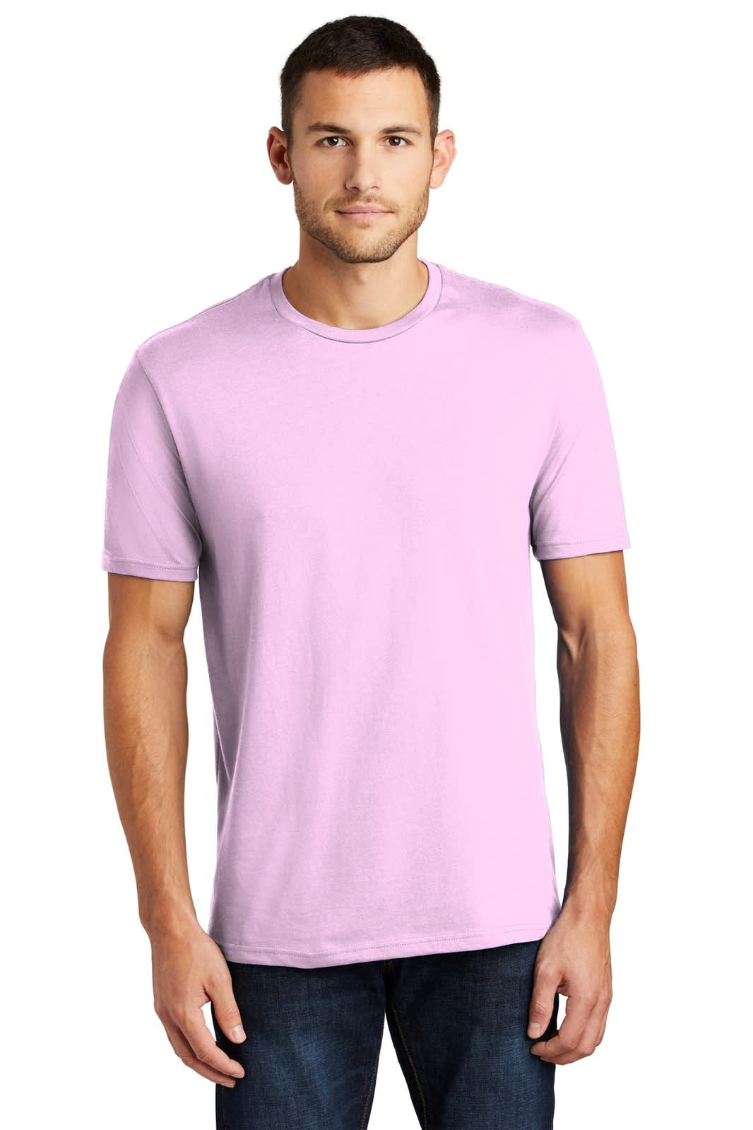 A man wearing a light pink crew neck t-shirt, paired with dark jeans. The shirt has a logo on the side.