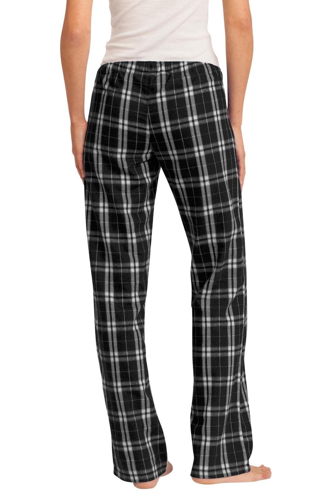 A pair of women's flannel plaid pants in black and white, featuring a loose fit and an elastic waistband.