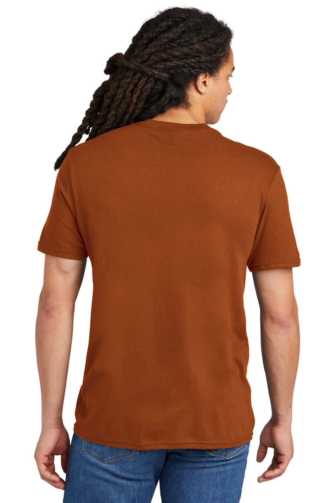 A young man with dreadlocks is wearing a plain brown t-shirt, viewed from the back. The shirt has a logo.