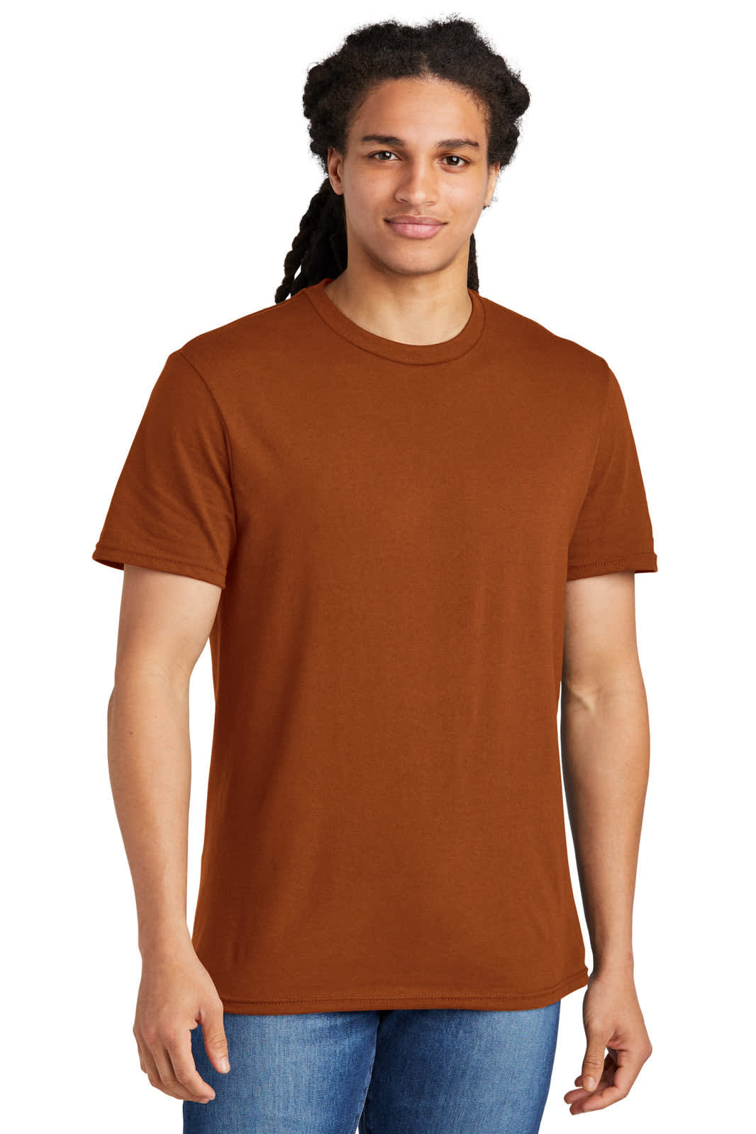 A young man wears a rust-coloured t-shirt with a straight fit, featuring a logo on the front.