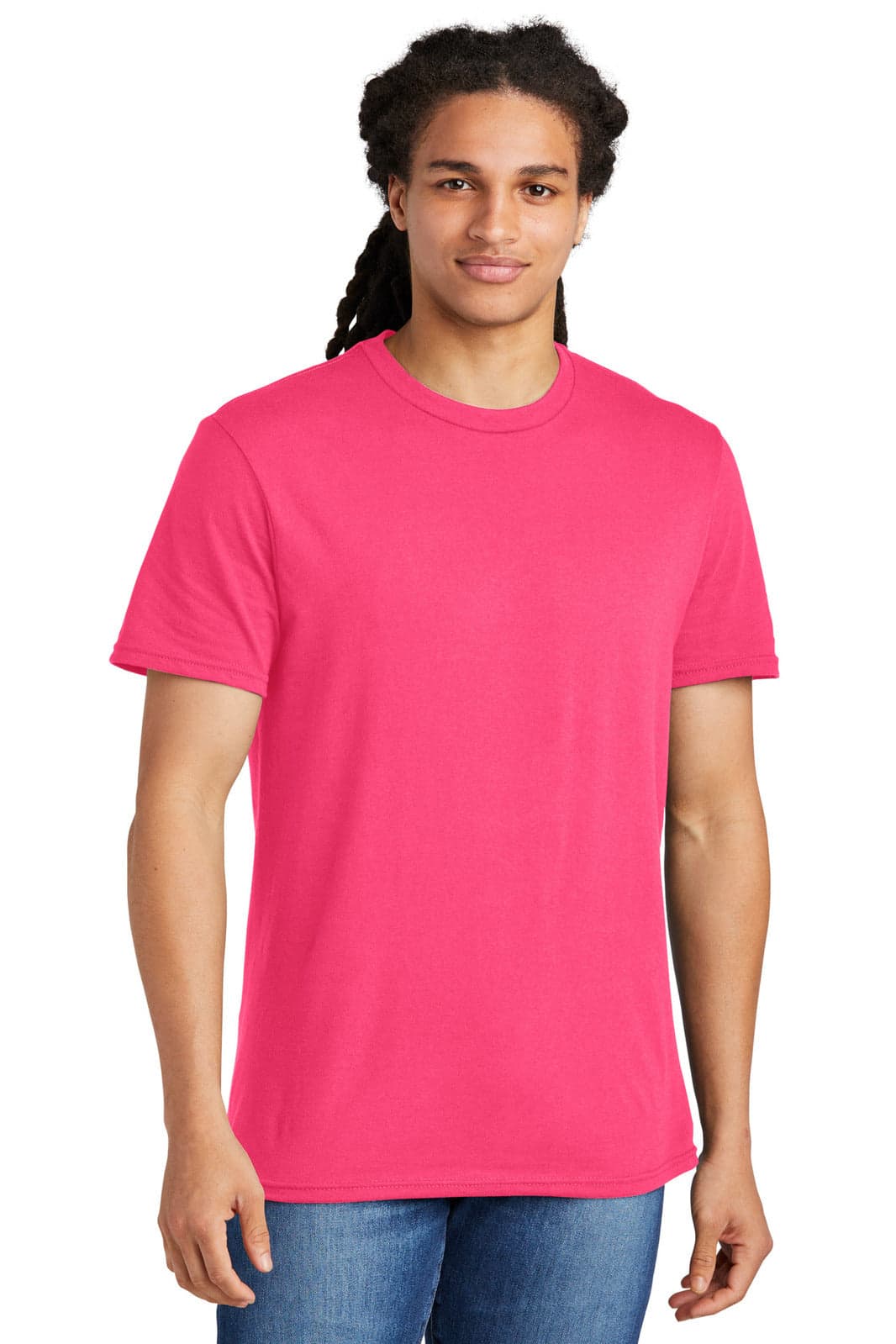A young man is wearing a bright pink T-shirt. The shirt features a logo on the front and is paired with blue jeans.