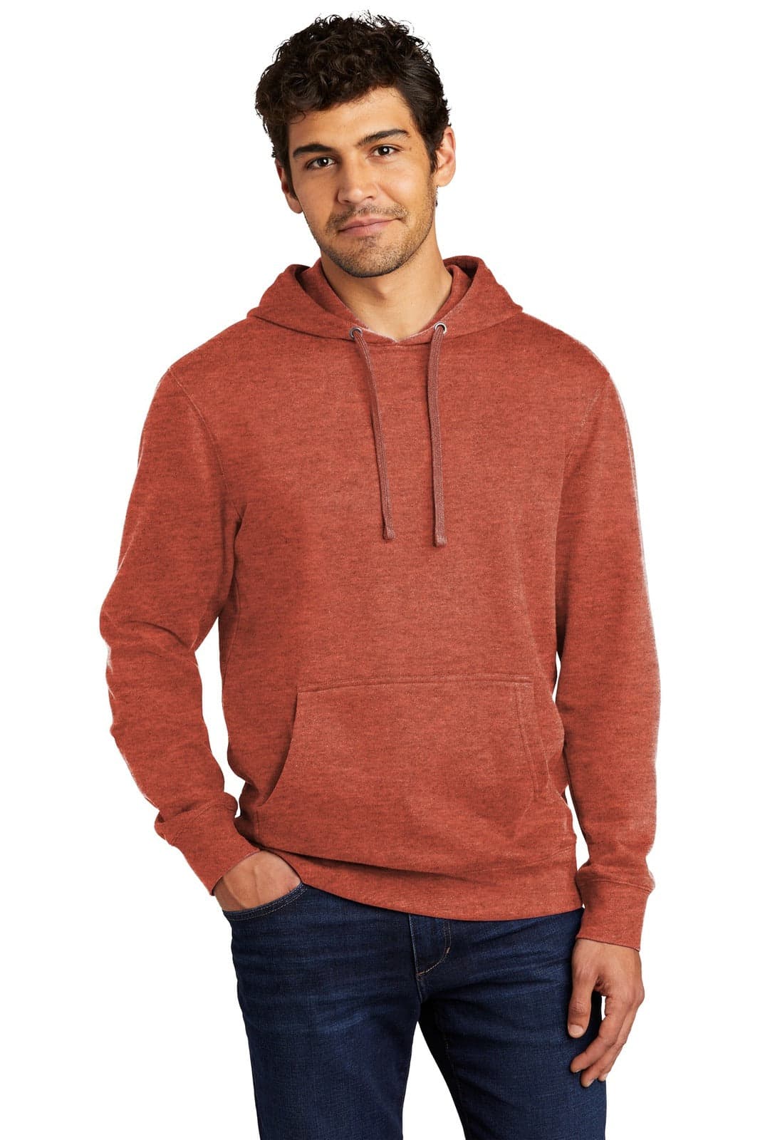 A man wearing a rust-coloured fleece hoodie with a front pocket and drawstrings. The hoodie has a logo.