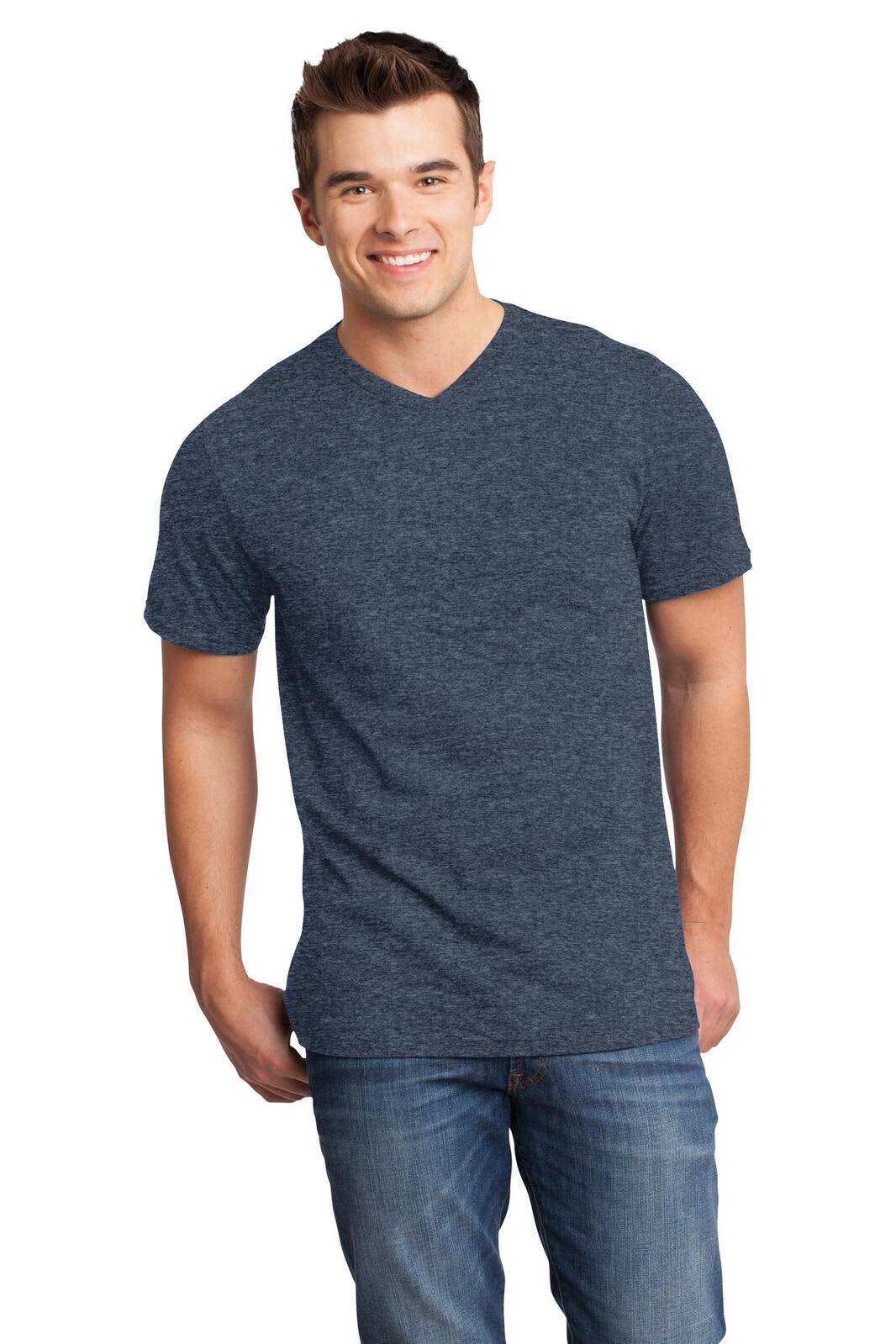 A young man wearing a navy blue v-neck t-shirt, standing confidently with hands in pockets and smiling.
