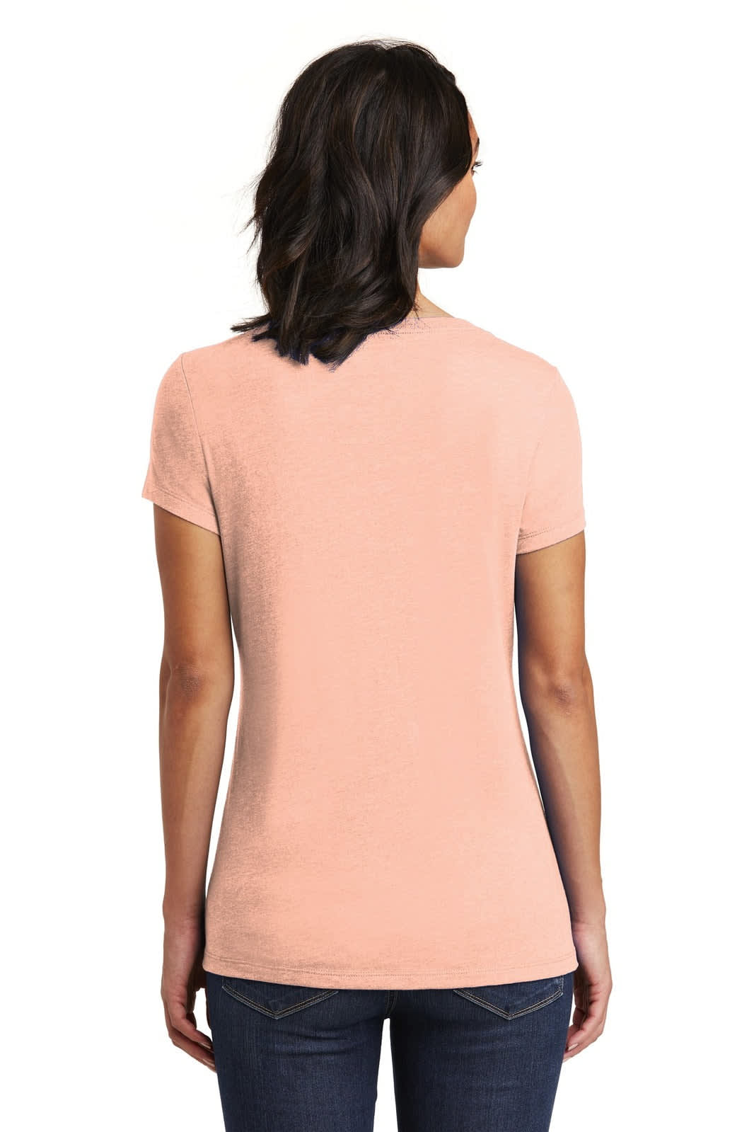 A woman is wearing a soft pink V-neck T-shirt, viewed from the back, with a fitted style.