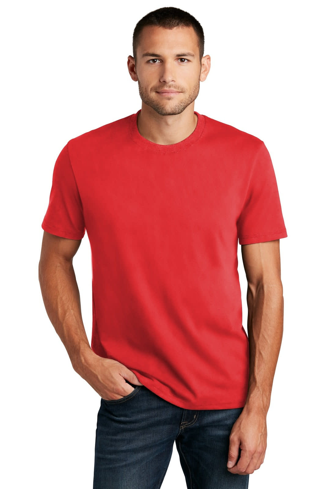 A man wearing a plain red t-shirt and jeans, standing confidently with a neutral expression. The t-shirt features a logo.