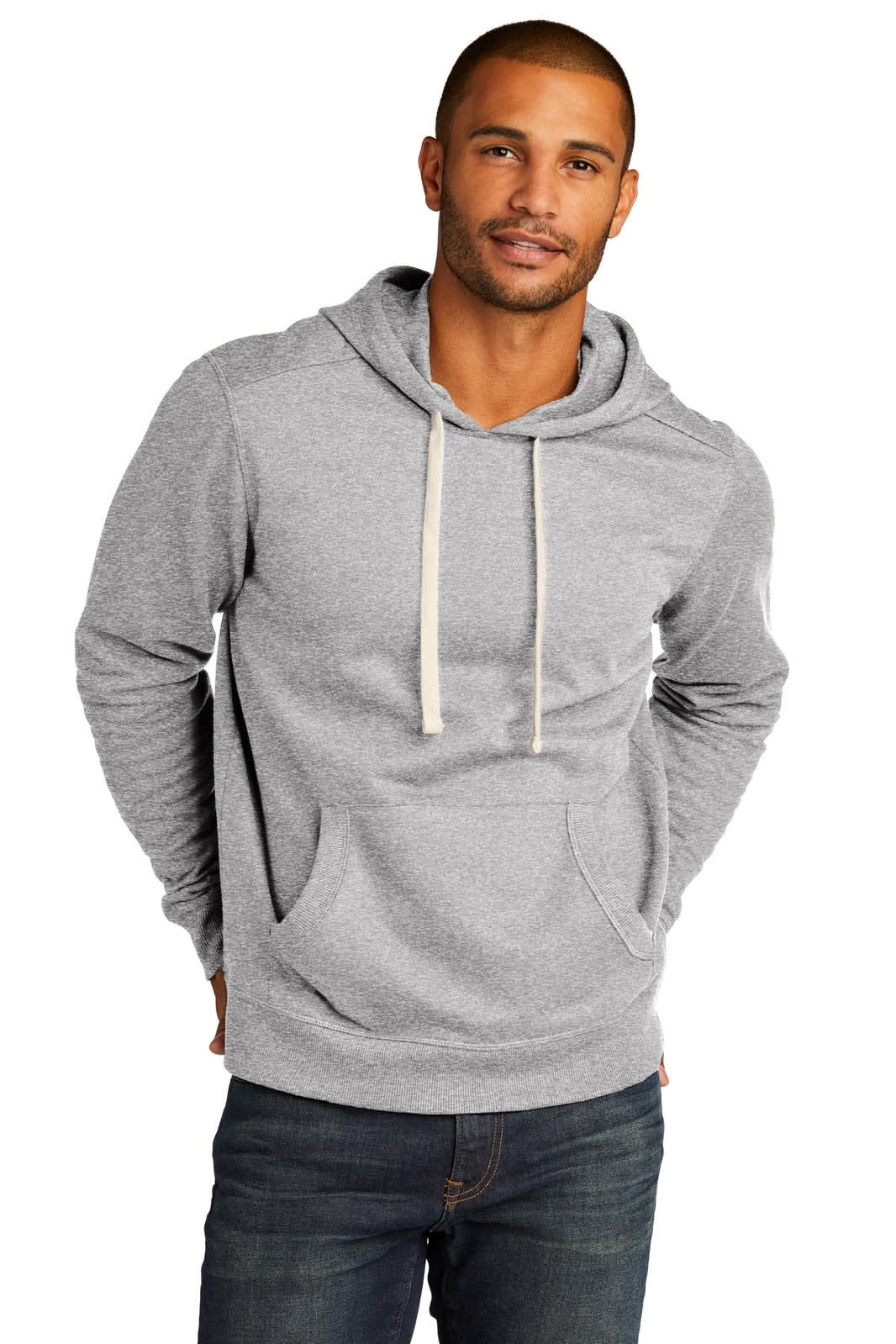 A grey hoodie with a front pocket and drawstring hood, worn by a model with short hair. The product features a logo.