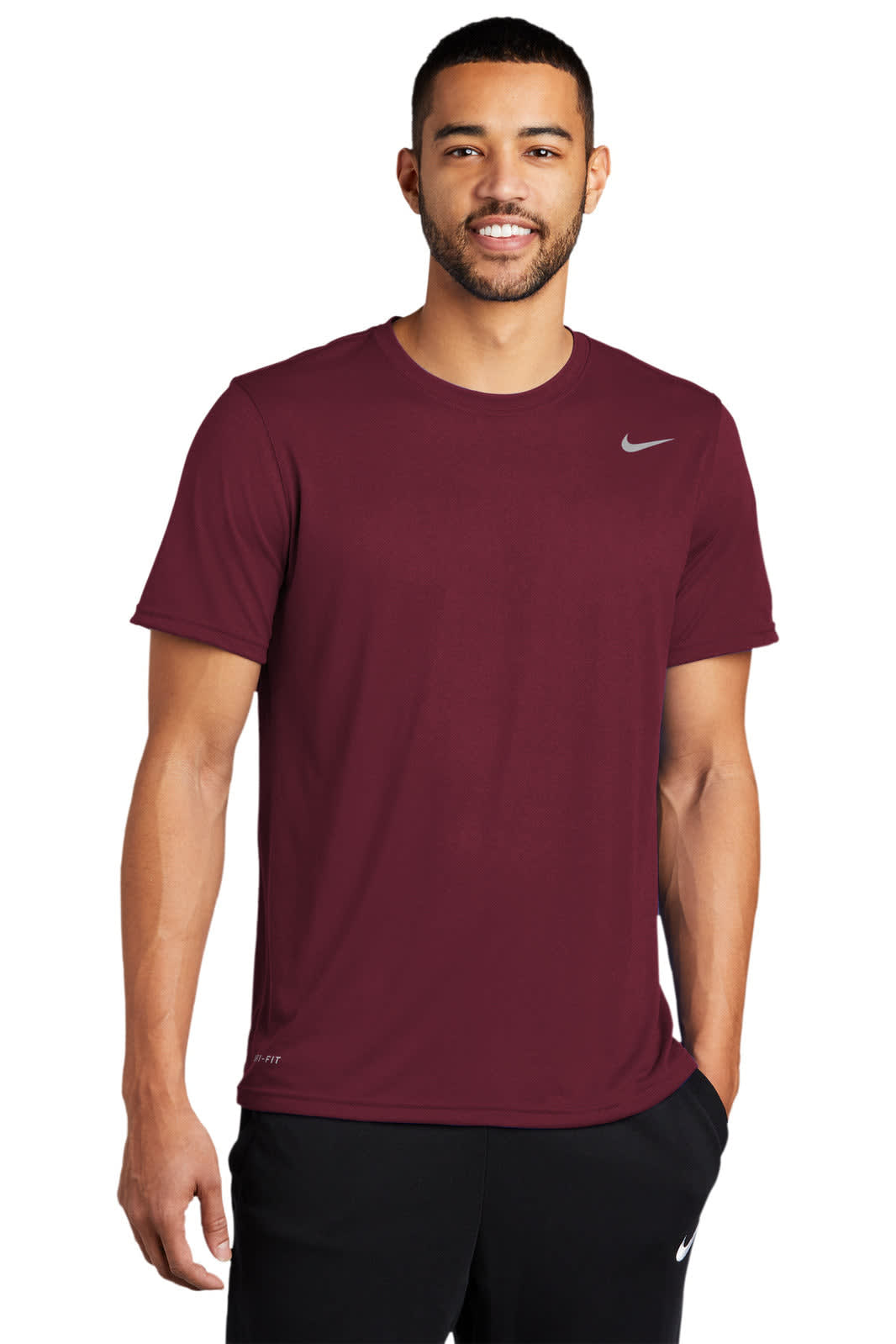 A maroon Nike Team rLegend Tee featuring a logo, worn by a man. The shirt has short sleeves and a crew neckline.