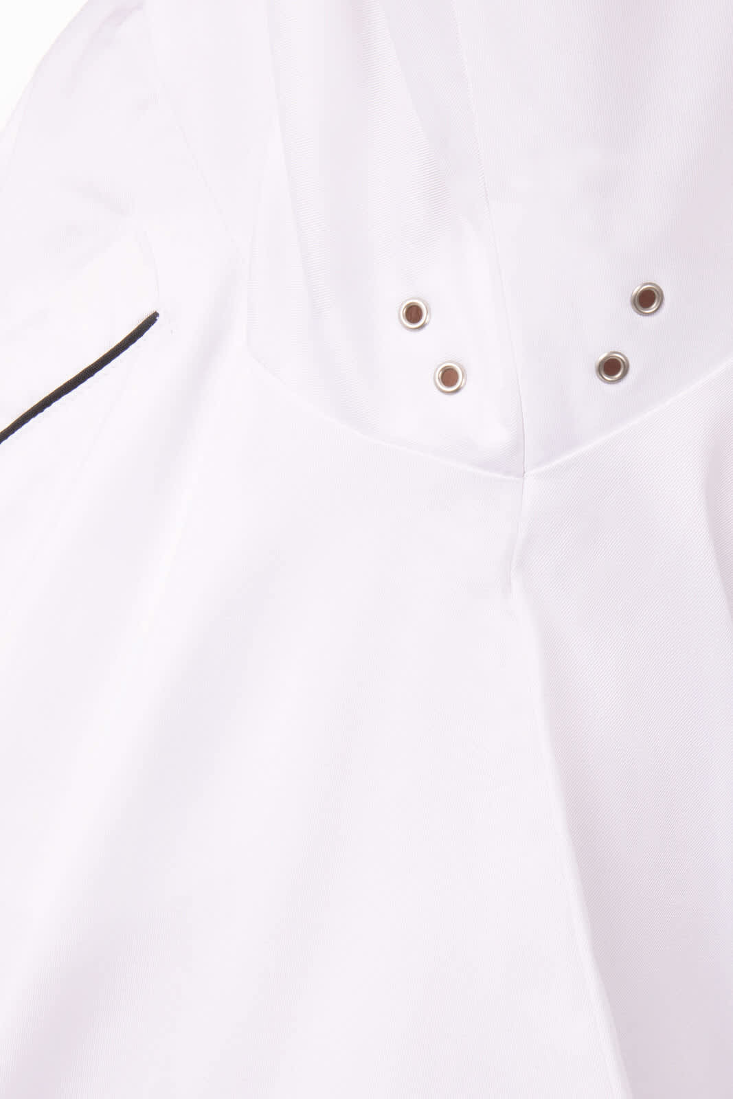 A white premium cotton chef jacket featuring metal eyelets and a subtle black trim. It includes a logo.