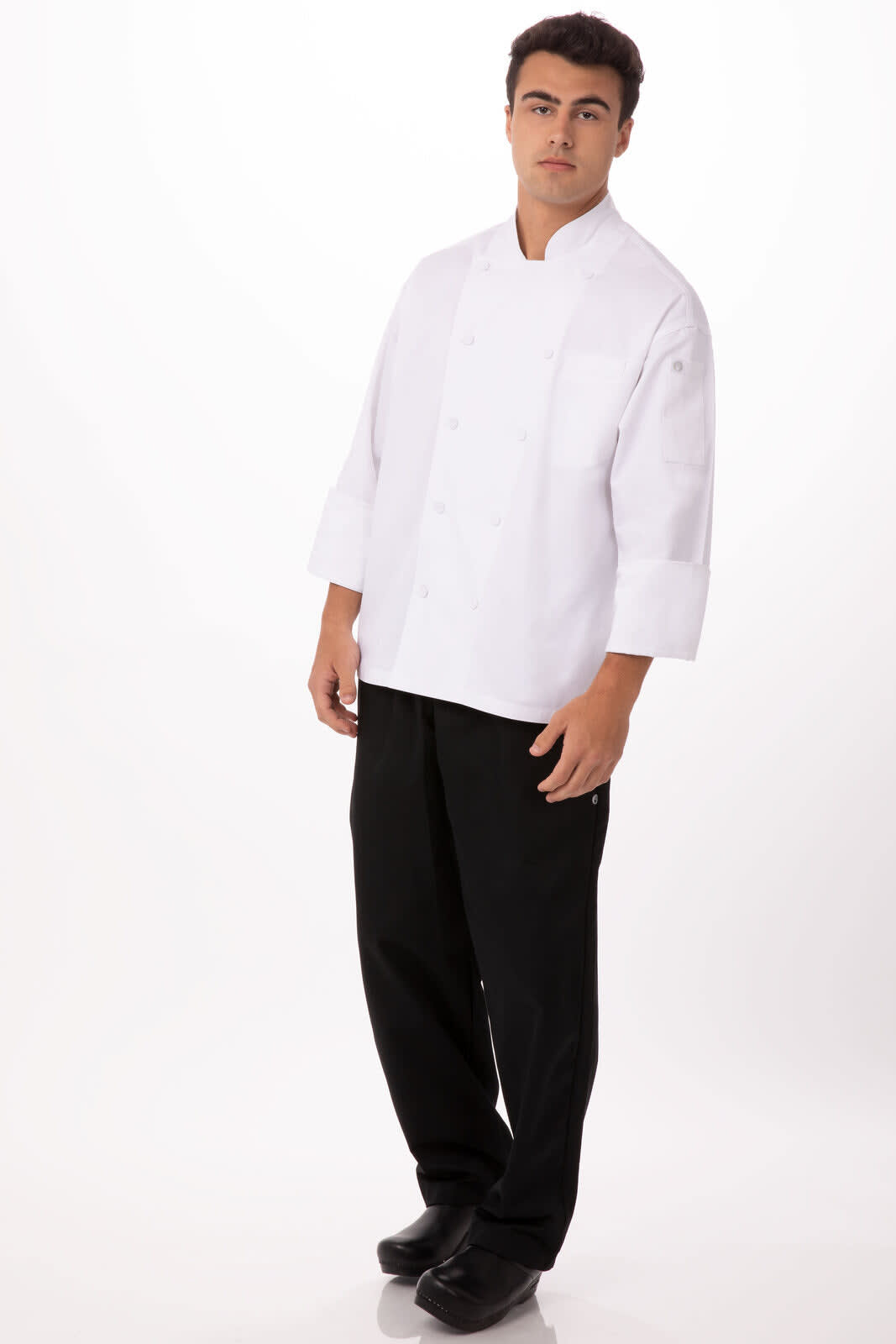 A white chef jacket worn by a model, paired with black chef pants and shoes, featuring a branding logo.