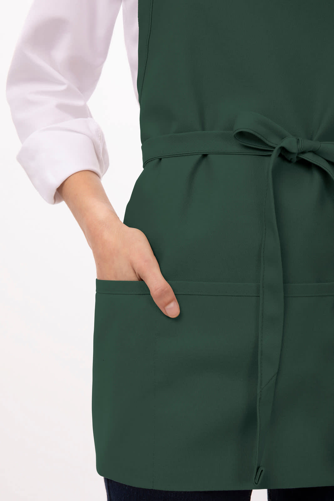 A green apron with three pockets and a tied waist, featuring a hand in one of the pockets.