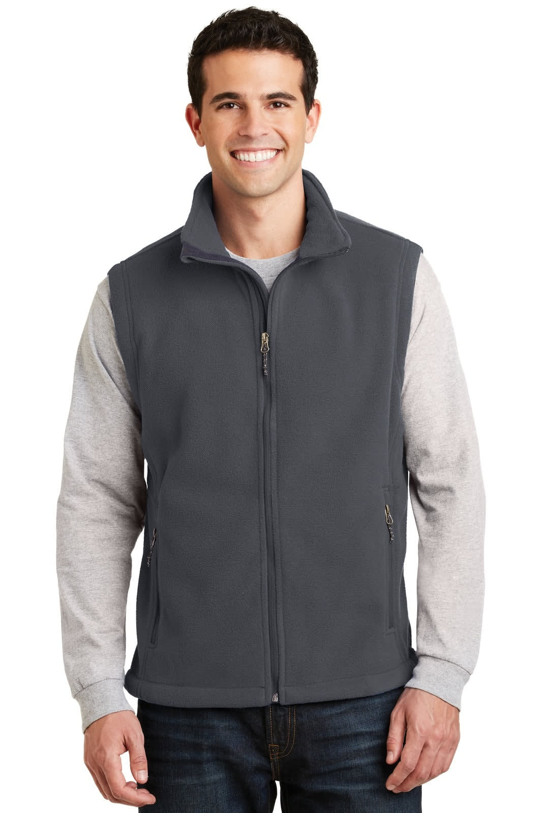 A man is wearing a grey fleece vest with a zip front and a high collar, over a grey long-sleeve shirt.