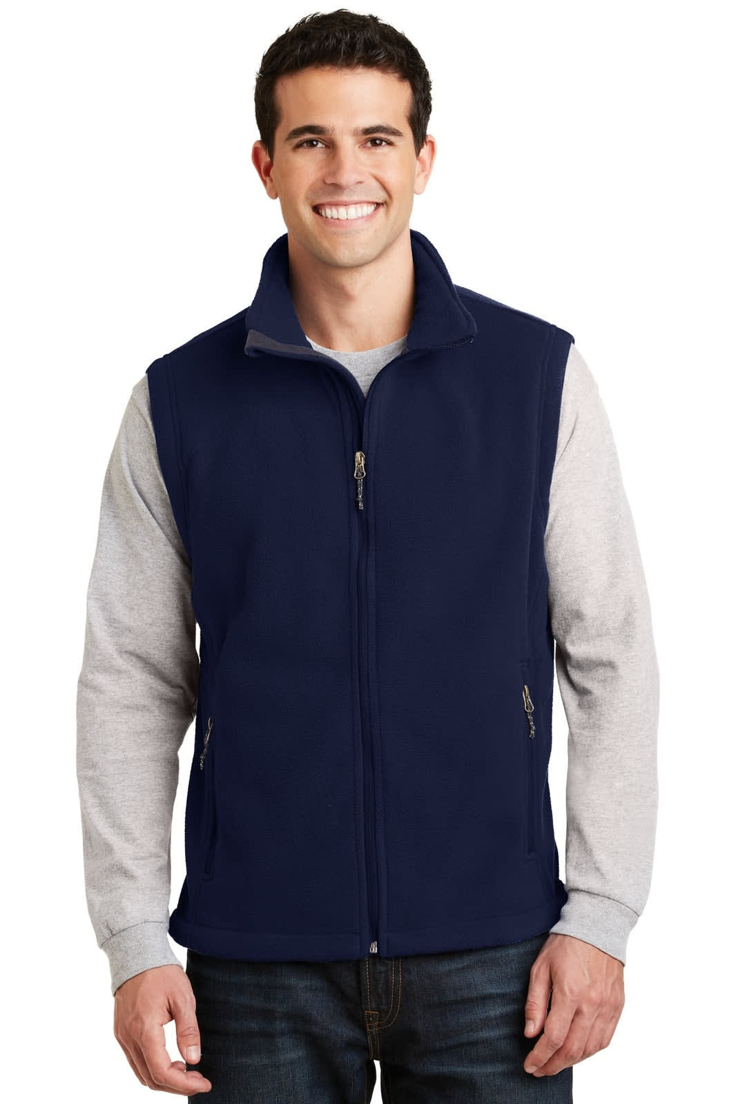 A navy fleece vest with a zip front, featuring side pockets and a logo. The model wears a grey long-sleeve shirt underneath.
