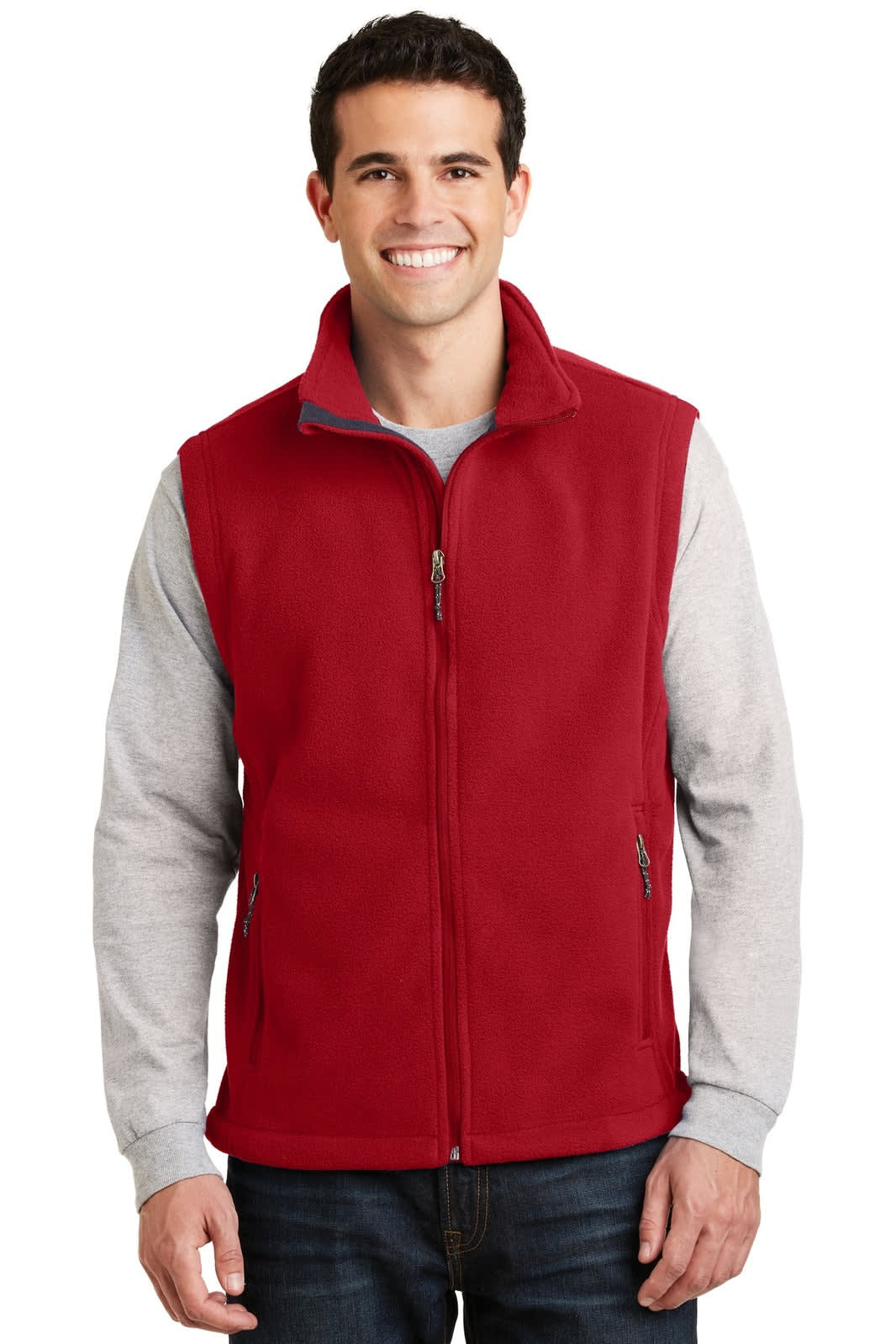 A red fleece vest with a zip front, featuring pockets and a logo, worn by a smiling man in a grey long-sleeve shirt.