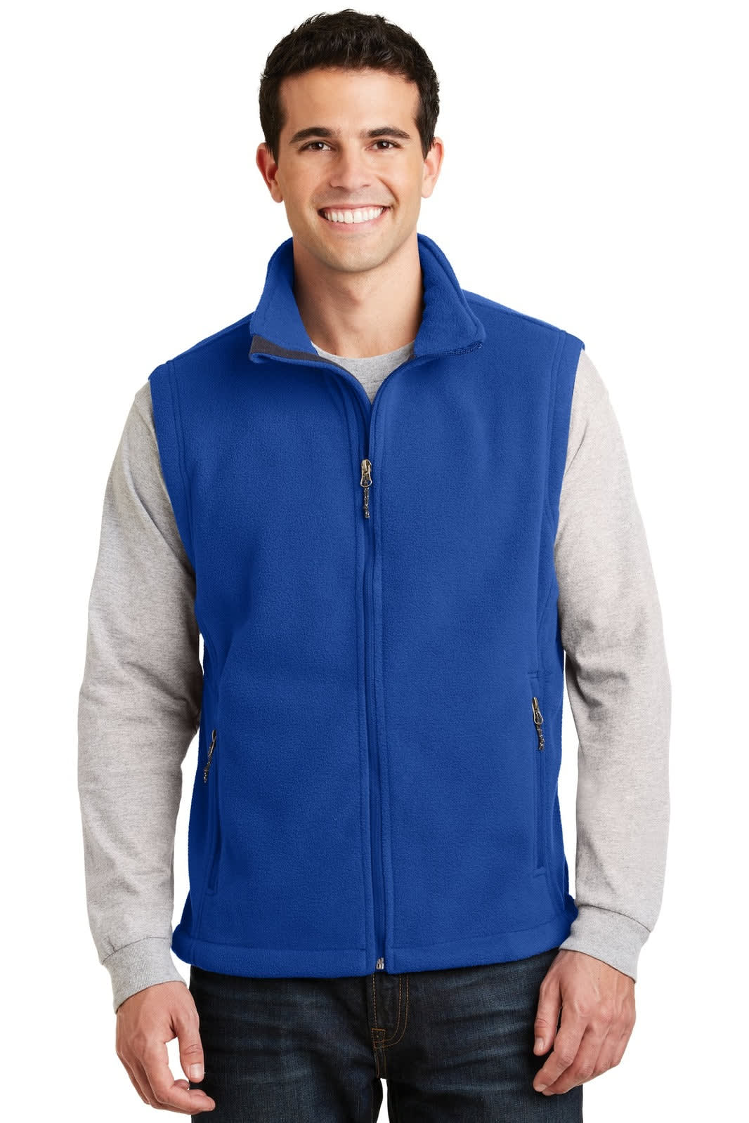 A man wearing a blue fleece vest with a zip-up front, paired with a light grey long-sleeve shirt underneath.
