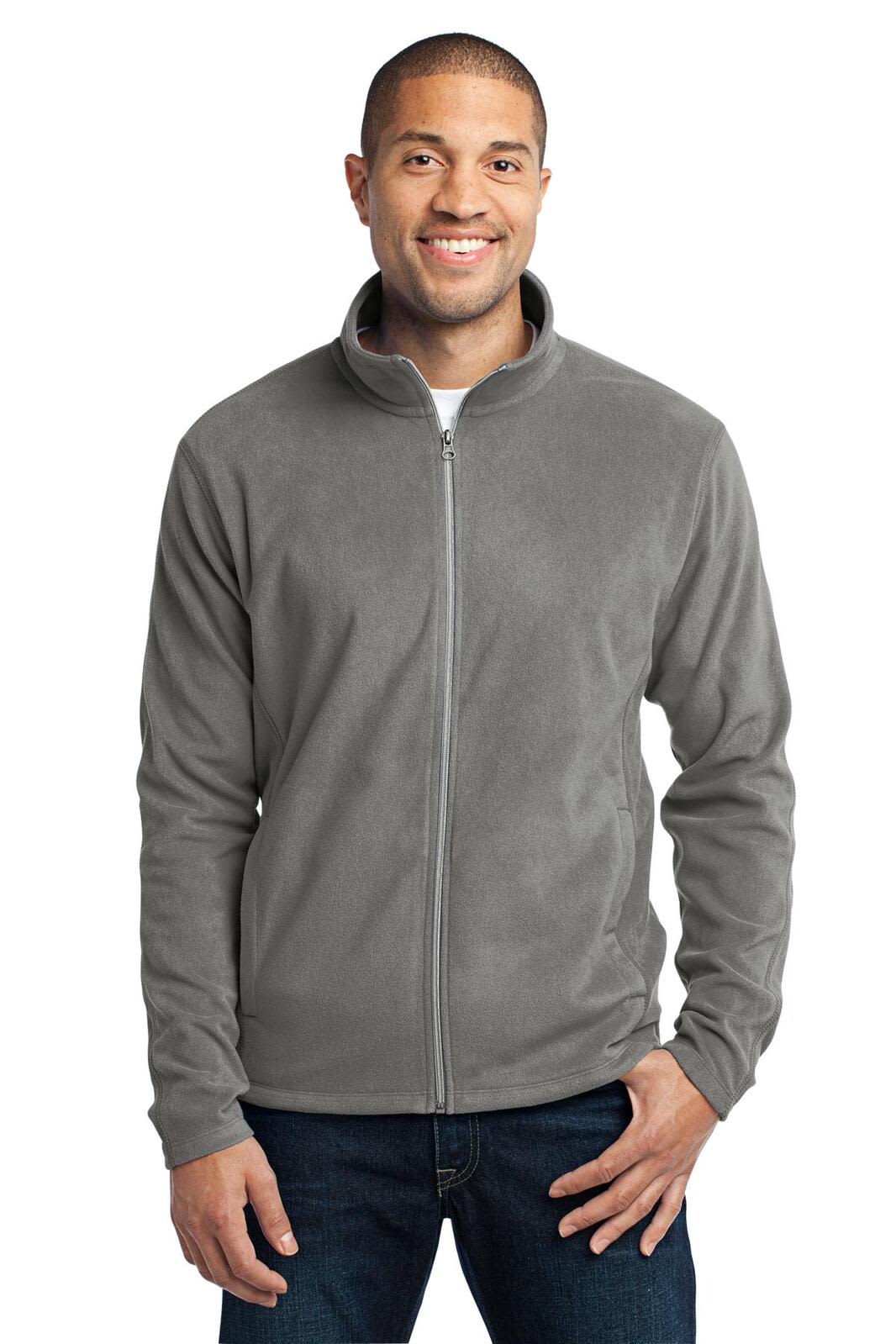 A man wearing a grey microfleece jacket with a zip front and a stand-up collar, featuring a logo.