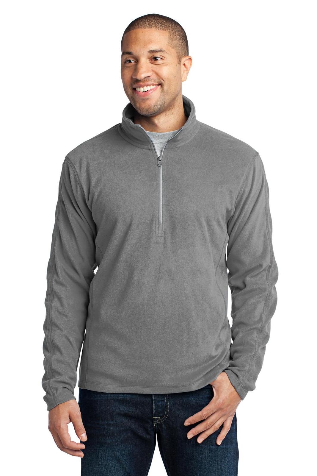 A grey microfleece 1/2-zip pullover with a collar and a logo, modeled by a man.