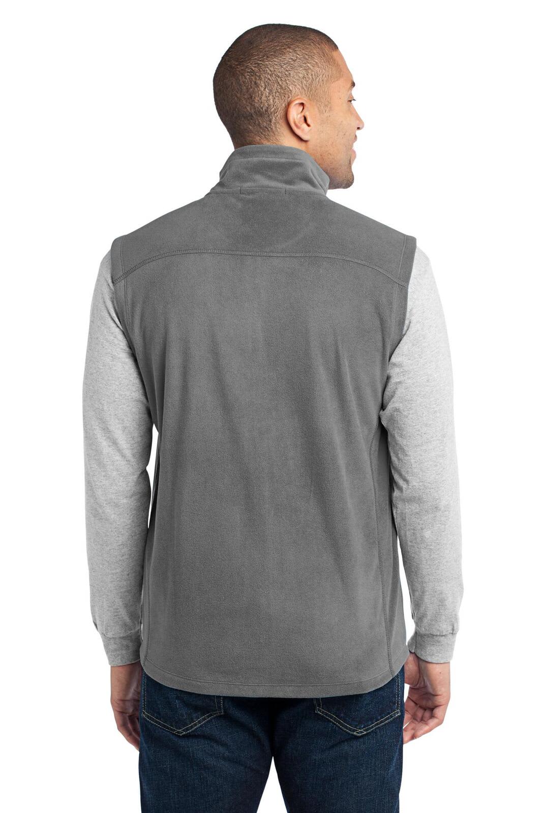 A man wears a grey microfleece vest from the back, with long sleeves visible underneath. The vest features a collar and has a logo.