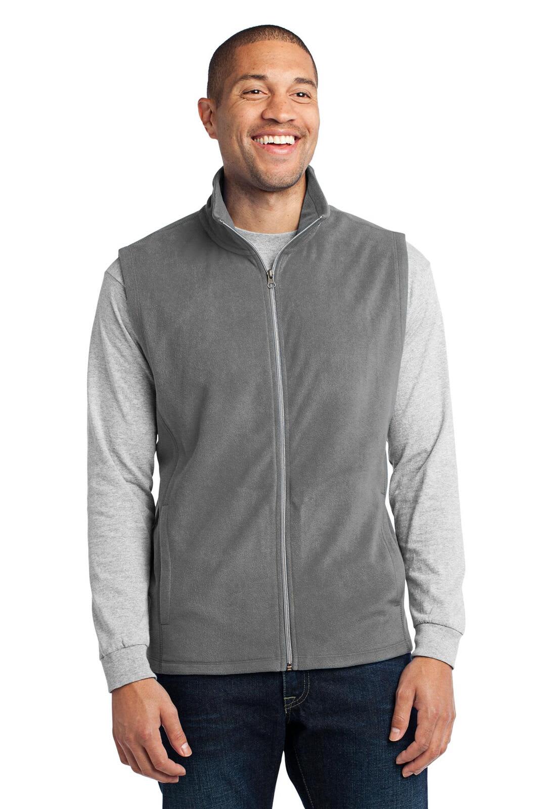 A grey microfleece vest worn over a long-sleeve shirt, featuring a zip closure and a logo.