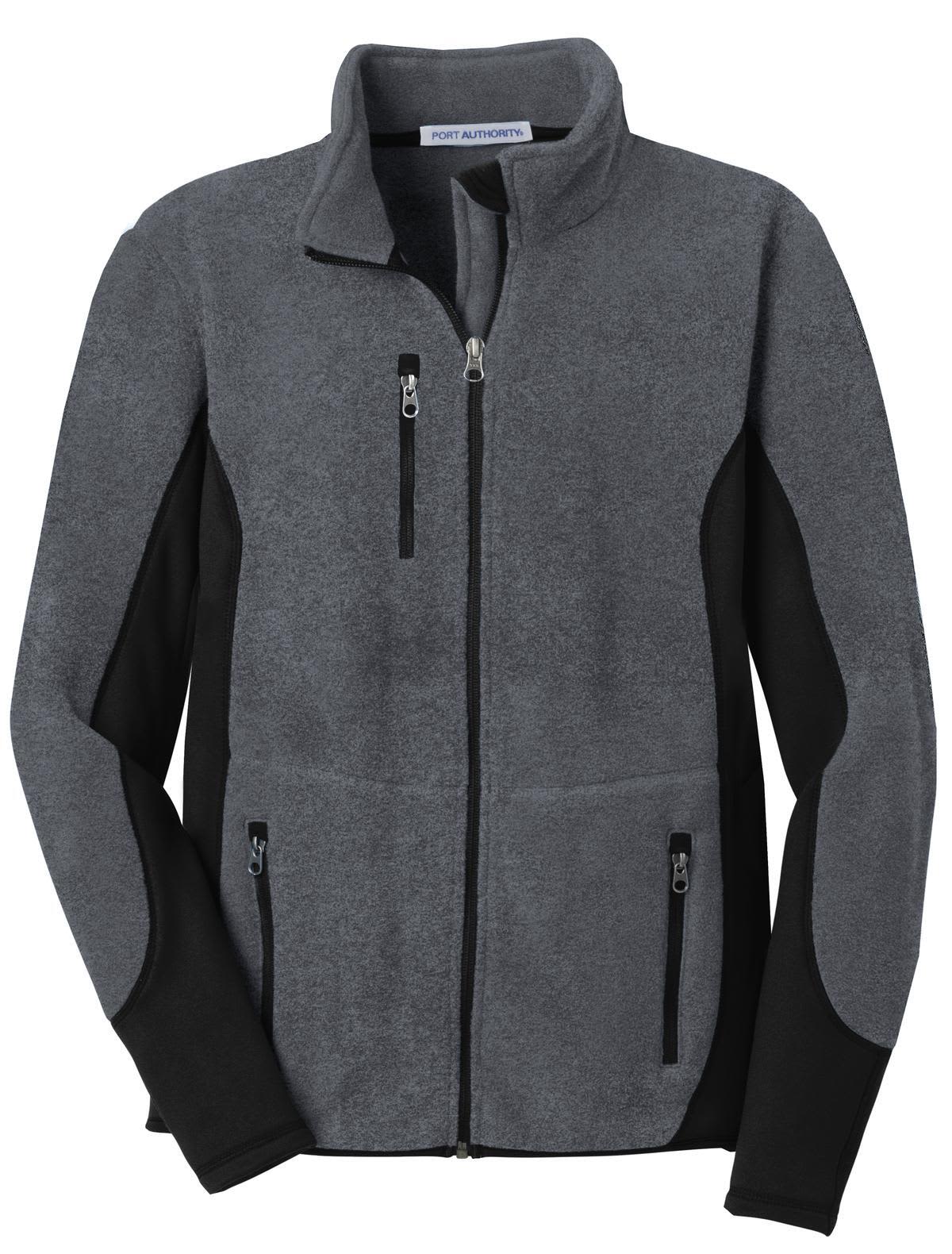 A grey and black full-zip fleece jacket featuring two front pockets and a zippered chest pocket. It has a logo on it.