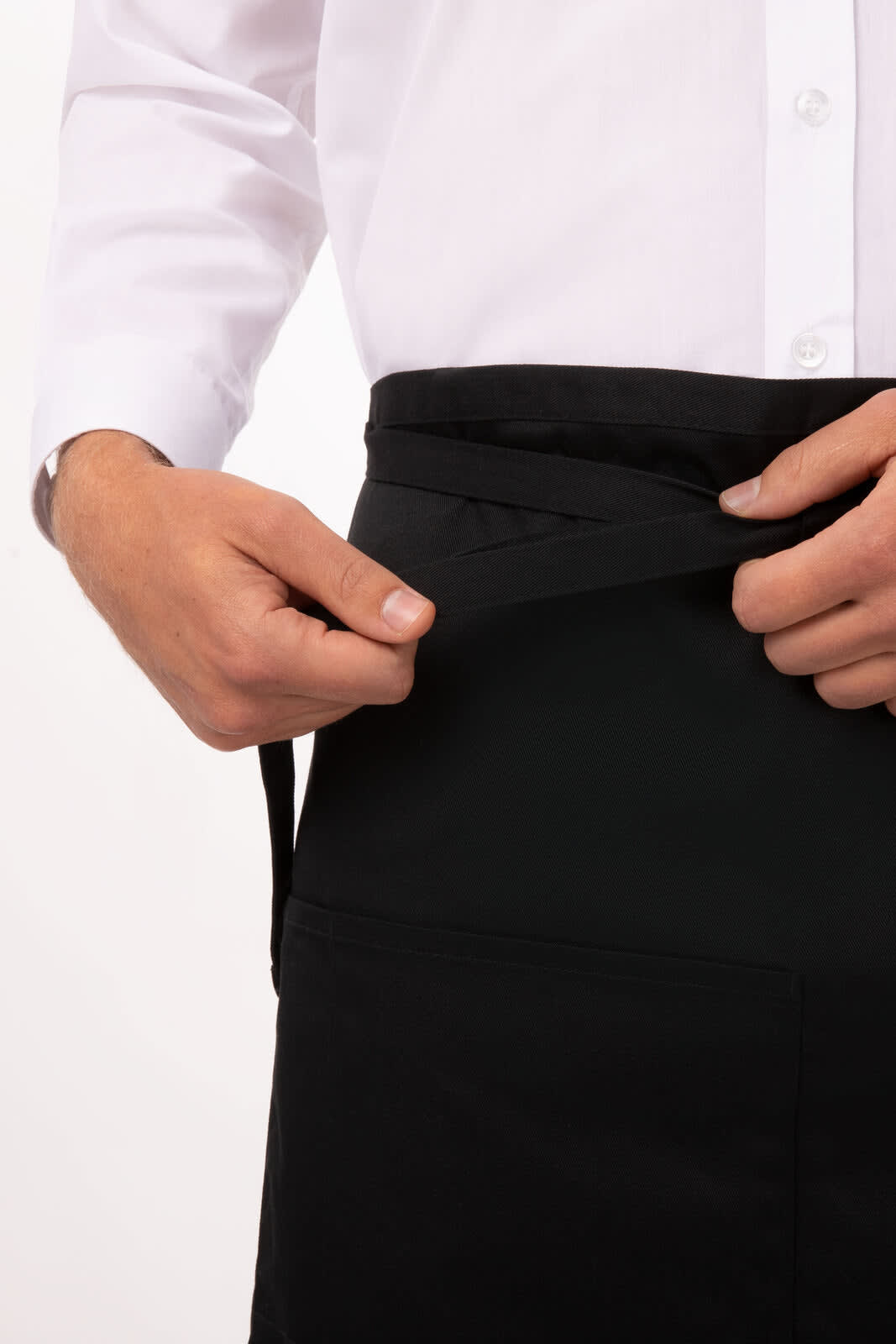 A black Bistro apron with a person adjusting the waist tie, featuring a simple design and a front pocket.