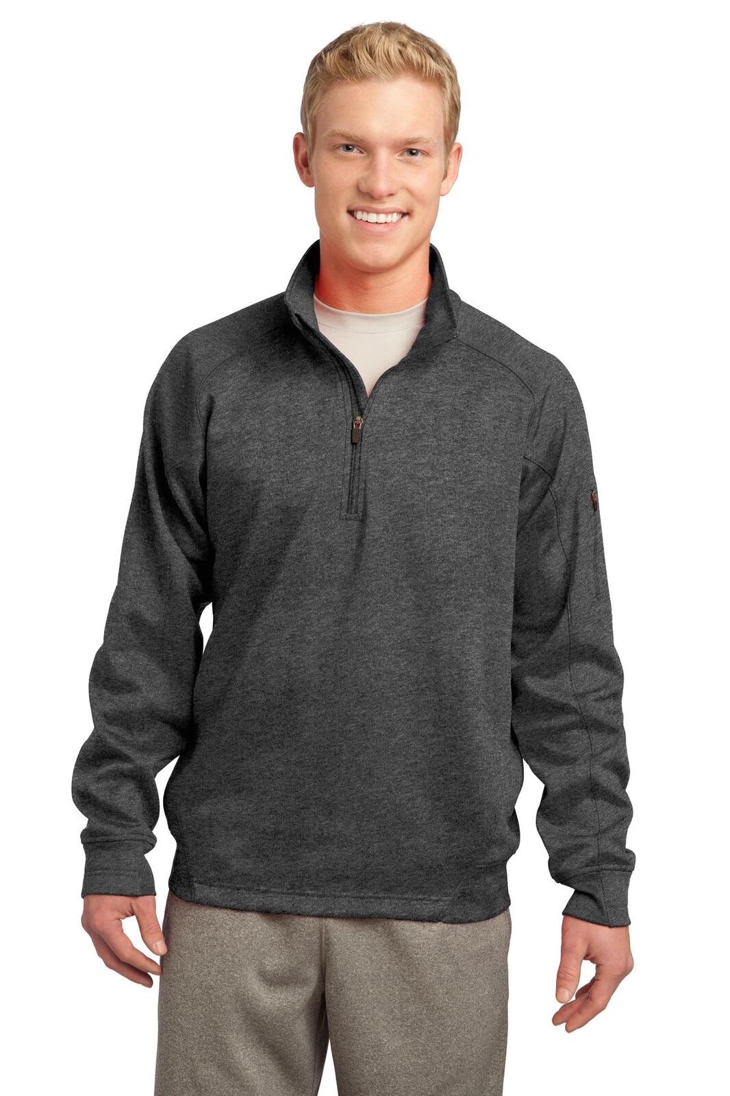 A man wearing a dark grey Sport-Tek Tech Fleece 1/4-Zip Pullover with a logo on the chest.