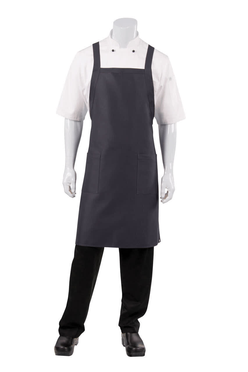 A grey cross-back bib apron worn over a white chef's shirt, displayed on a mannequin. Includes a pocket and logo.