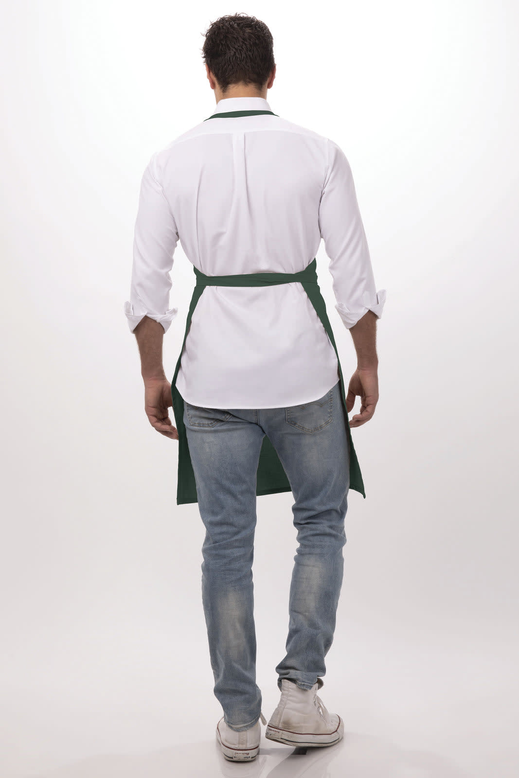 A person wearing a green bib apron over a white shirt, viewed from the back.