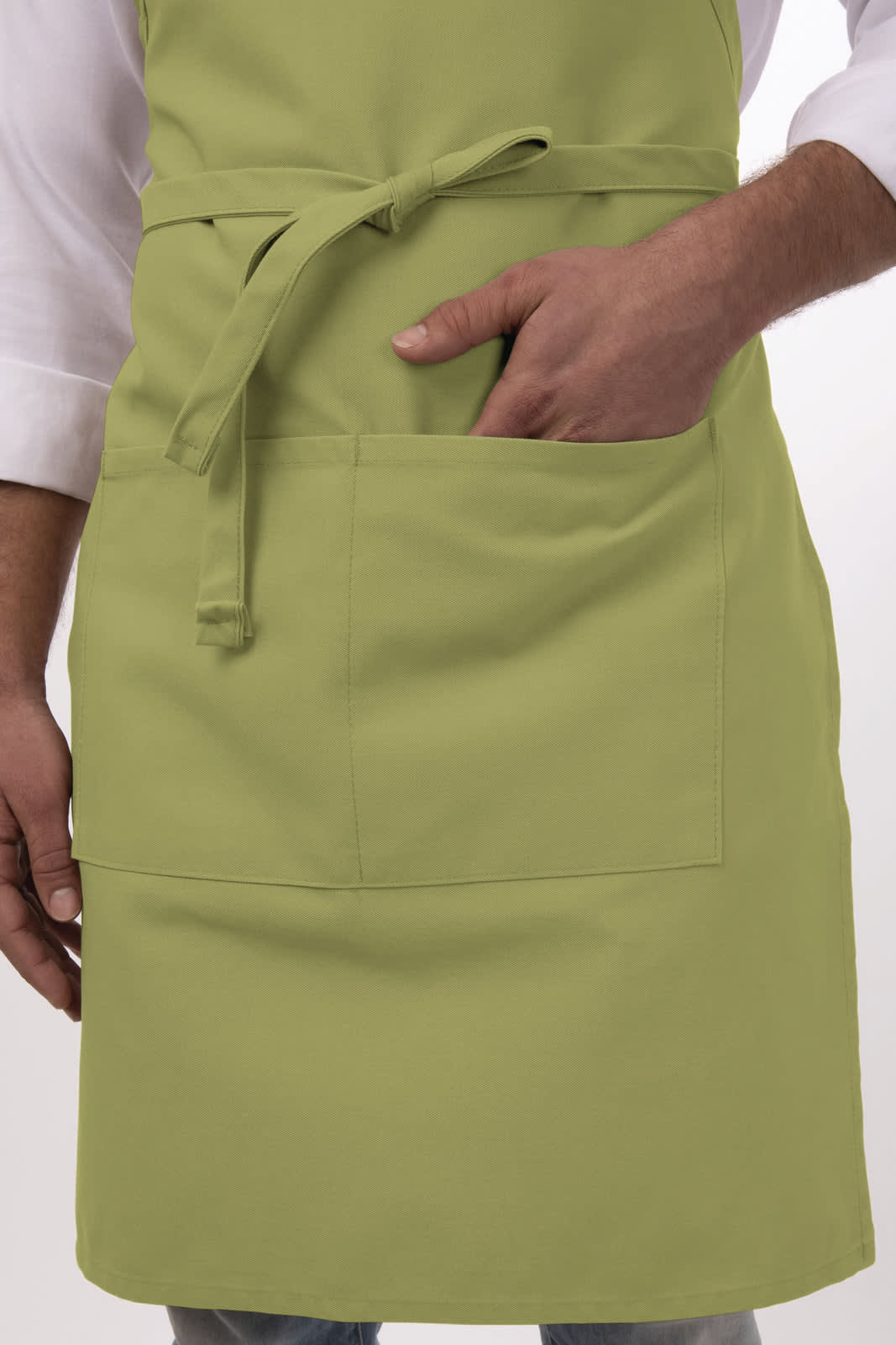 A light green bib apron featuring a front pocket and adjustable ties around the waist, worn by a person.
