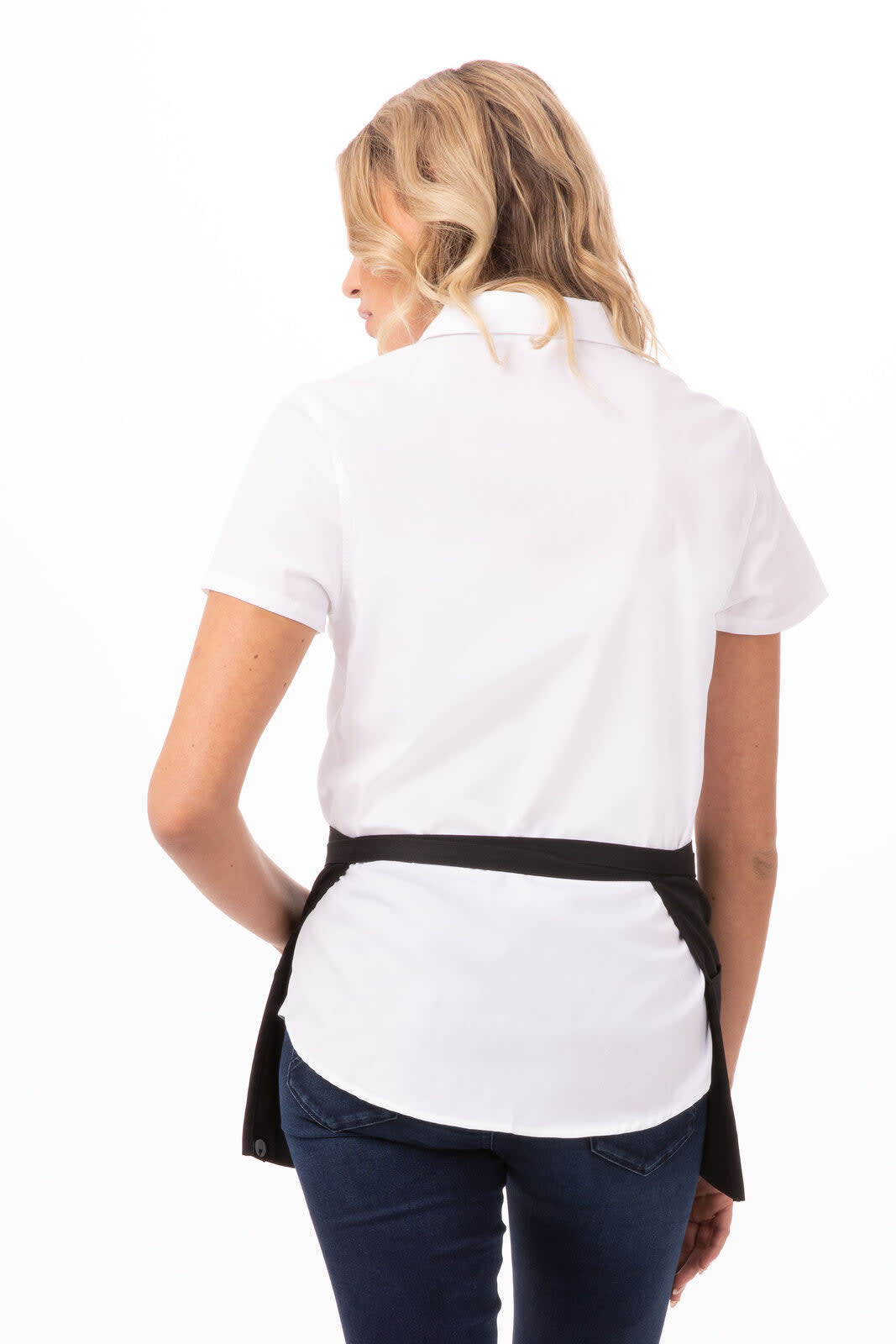 A waist apron in dark brown, worn over a white shirt, featuring a tied back design.