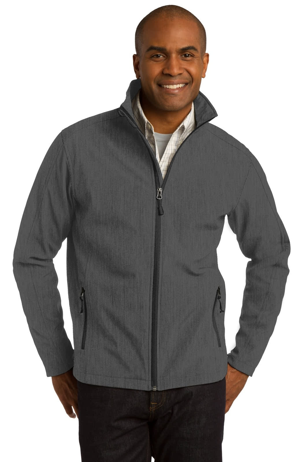 A man wearing a grey Port Authority Core Soft Shell Jacket with zipped pockets and a stand-up collar.