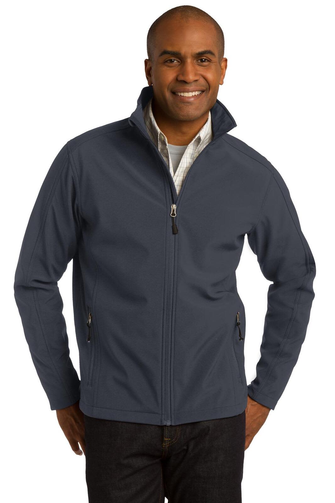 A man wearing a navy soft shell jacket with a zippered front and side pockets, featuring a logo.