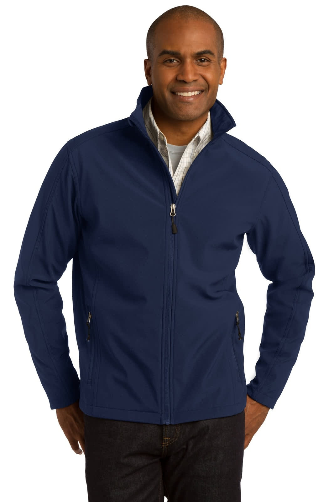 A man wearing a navy blue soft shell jacket with a collar and zippered front, featuring side pockets and a logo.
