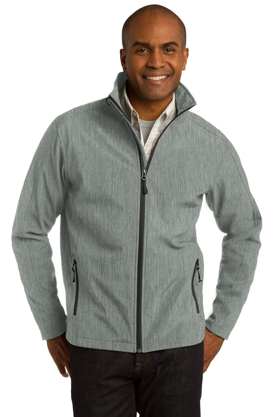 A man wearing a grey soft shell jacket with a stand-up collar and zip-up front. The jacket has two side pockets and a logo.