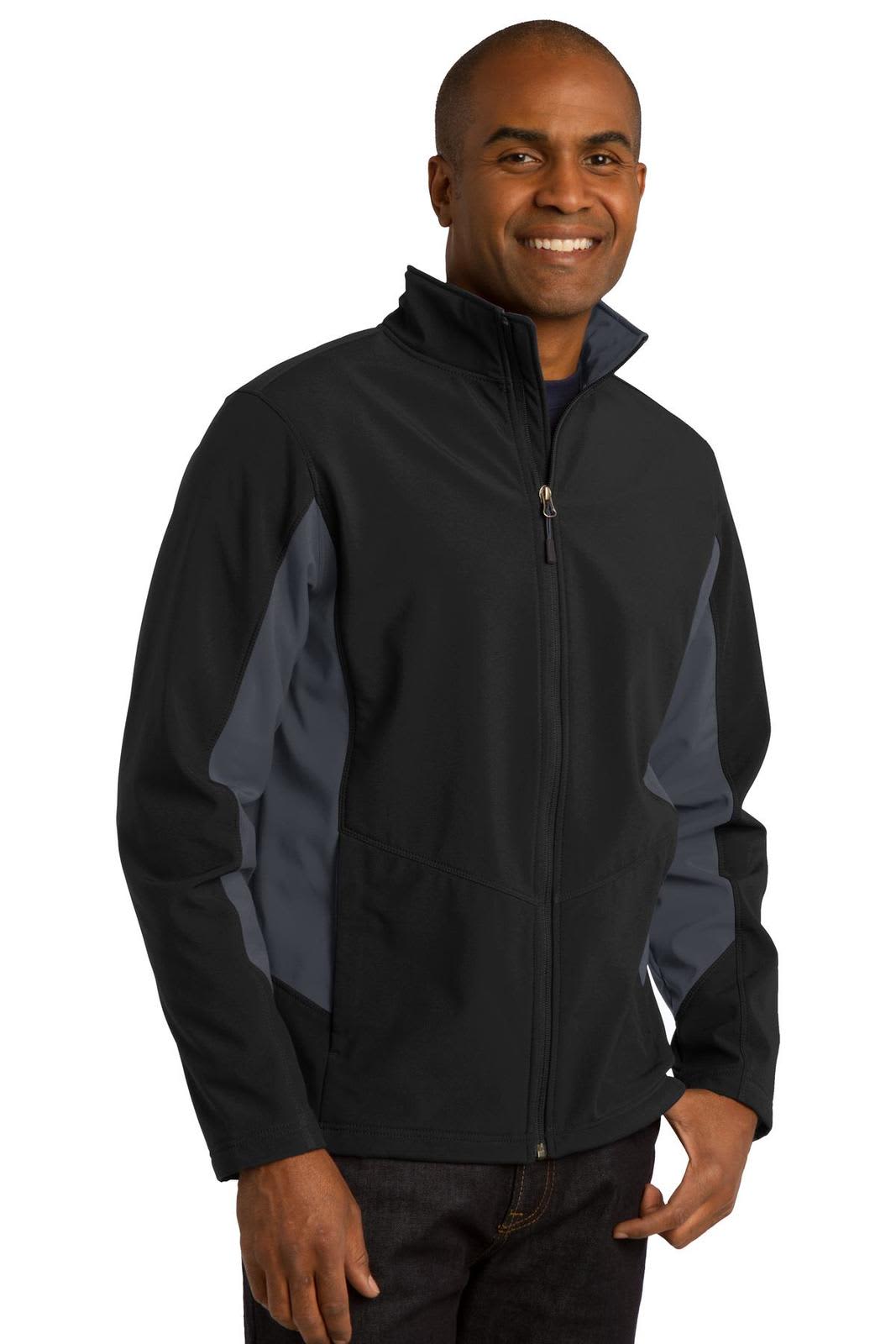 A man wearing a black and grey soft shell jacket with a zip closure and a stand-up collar.