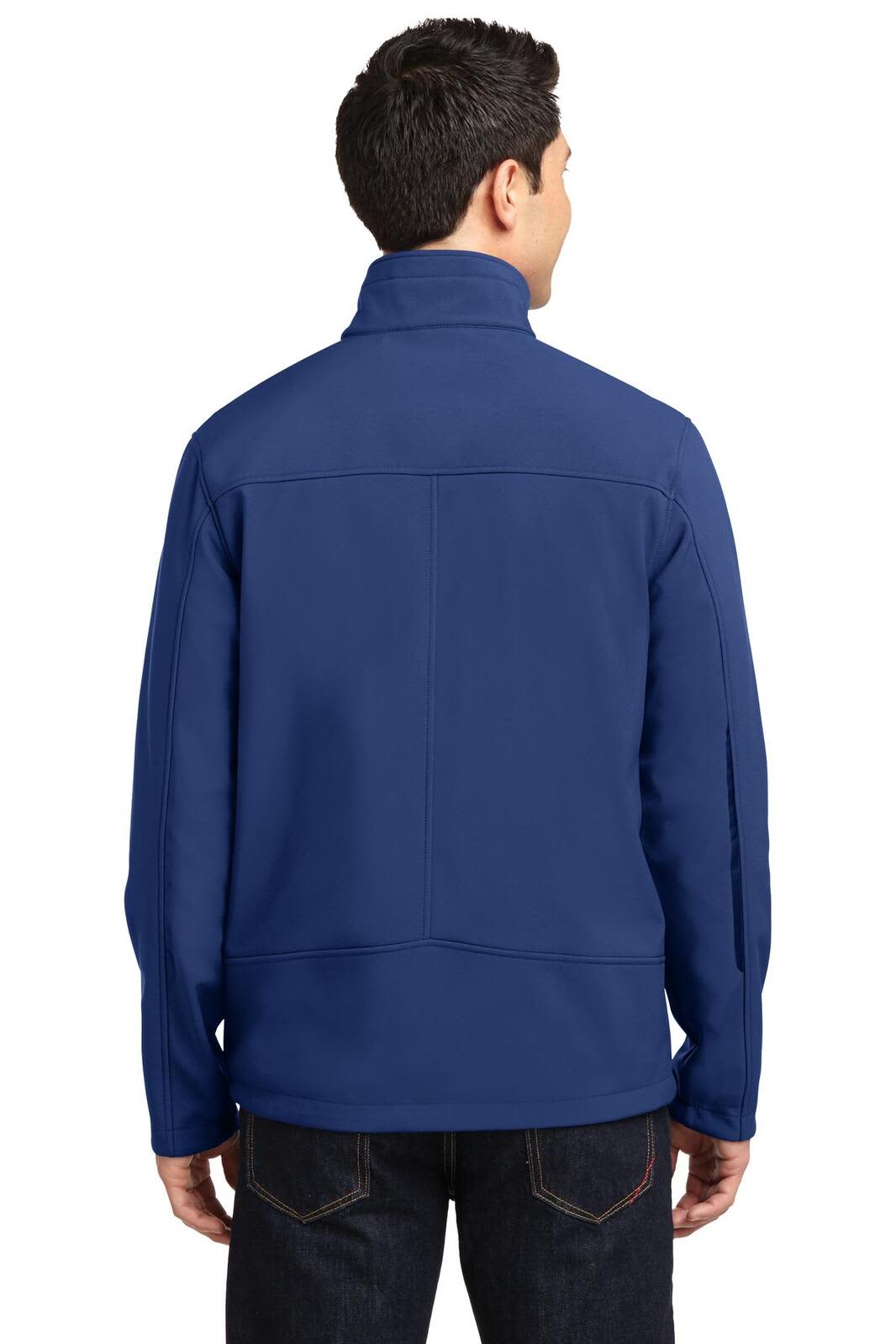 A man wearing a navy blue soft shell jacket, viewed from the back, featuring a logo on the upper left side.