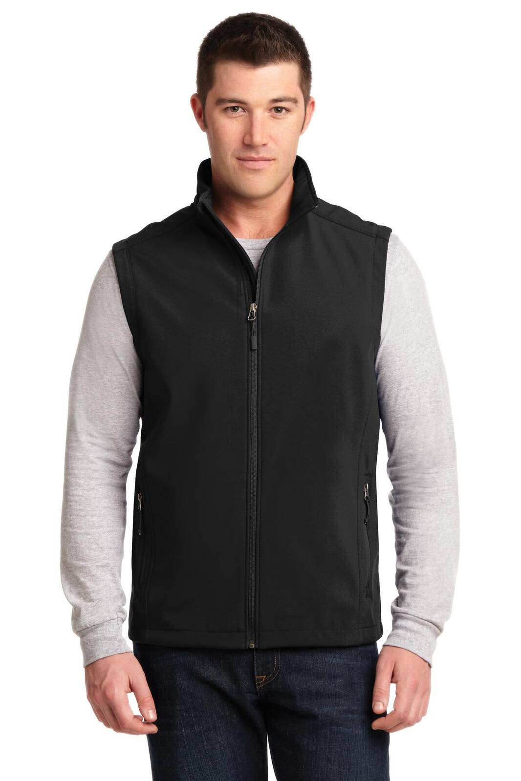 A black soft shell vest is worn over a grey long-sleeve shirt, featuring a front zipper and pockets.