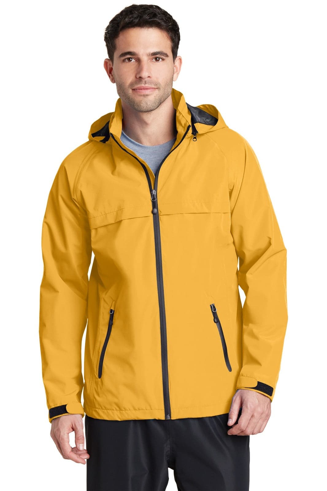 A man wearing a yellow Port Authority Torrent Waterproof Jacket with a hood and zippered pockets.