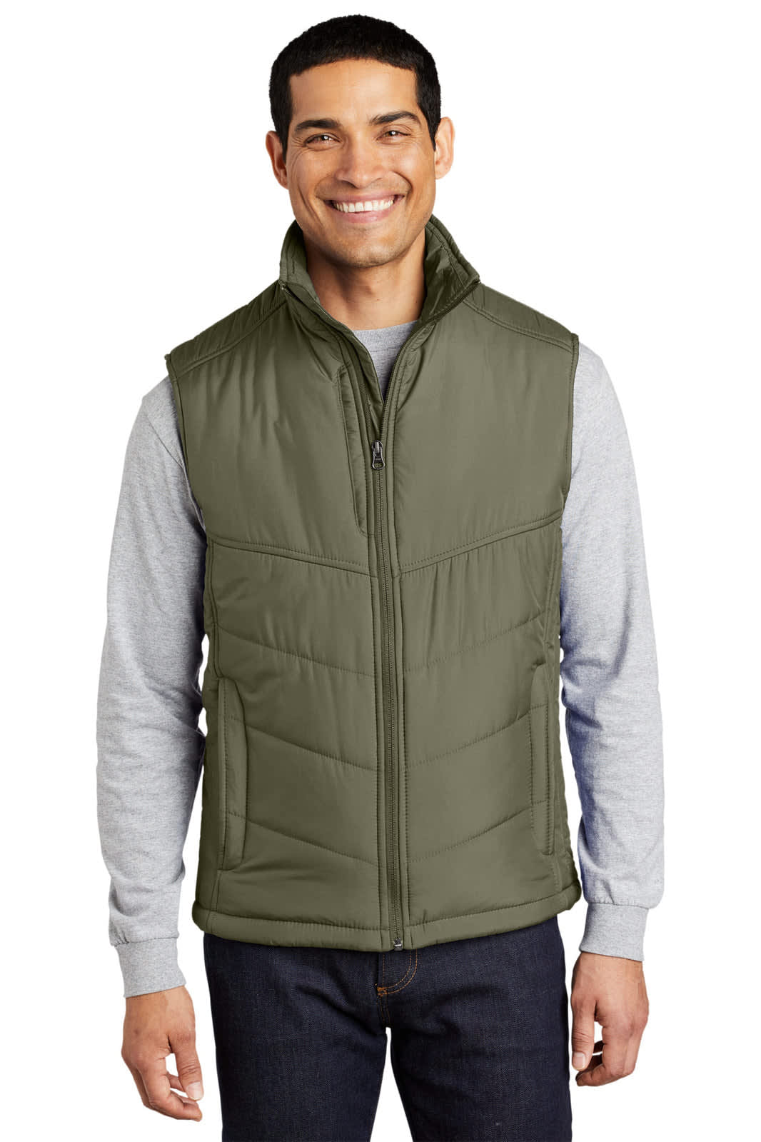 A puffy vest in olive green, featuring a zipped front and a high collar, worn by a smiling man in a grey long-sleeve shirt.