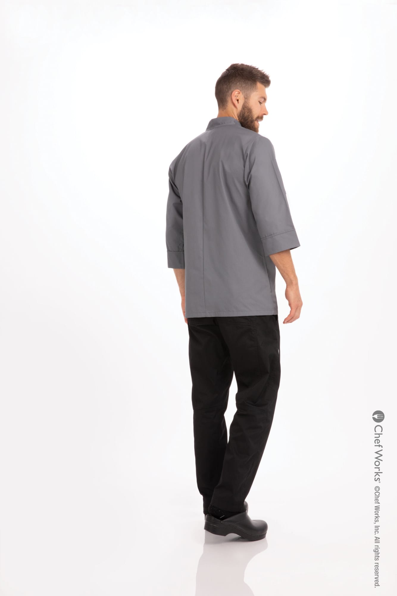 A men's chef jacket in grey with a stylish design, displayed from the back, paired with black pants.