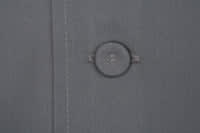 A grey chef jacket featuring a button detail at the front, showcasing its fabric texture.
