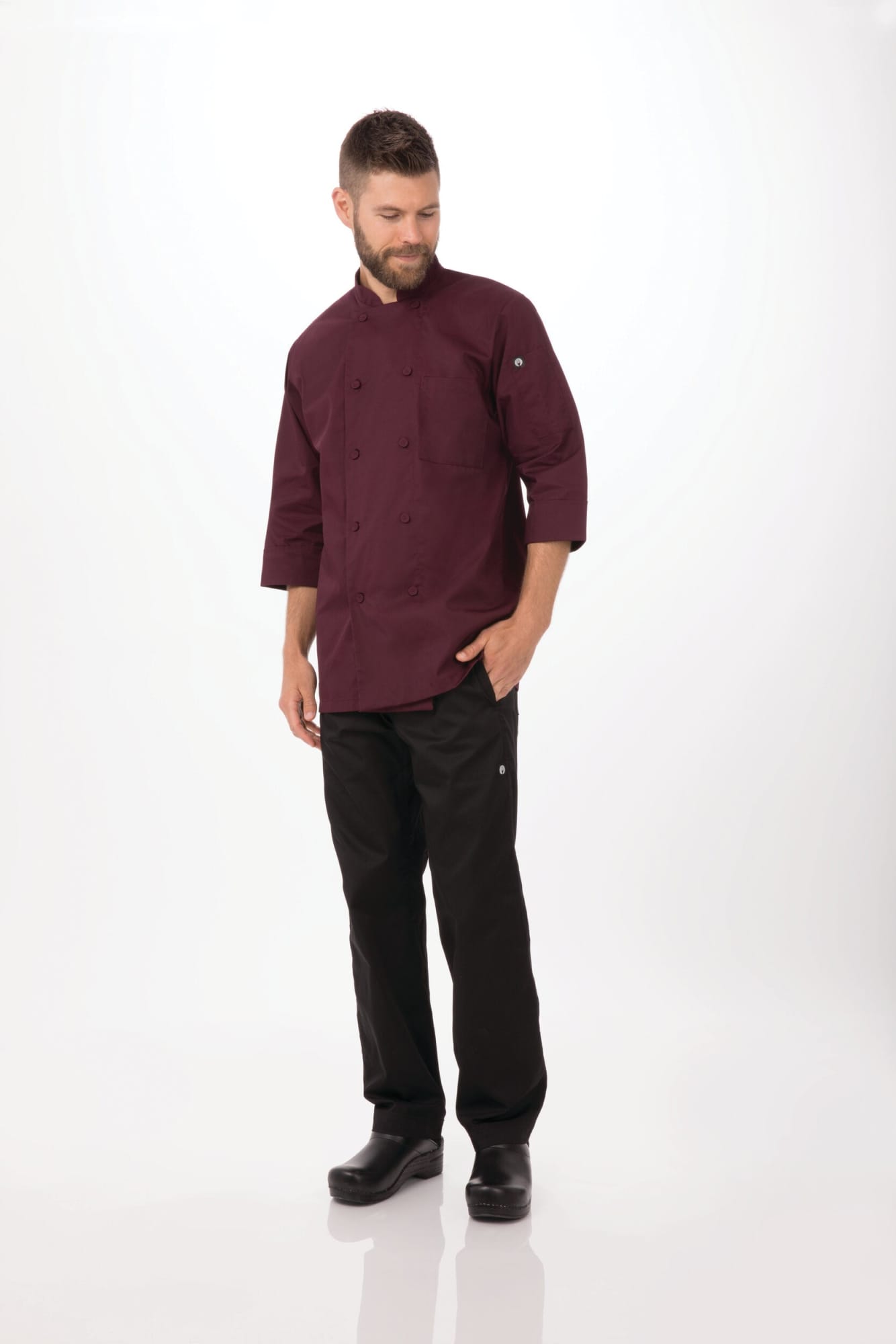 A men's chef jacket in burgundy, paired with black pants, featuring a logo on the jacket.