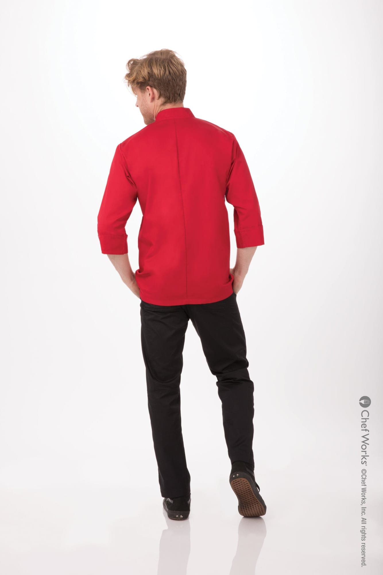 A red men's chef jacket worn by a man, viewed from the back, paired with black trousers. It features a logo.