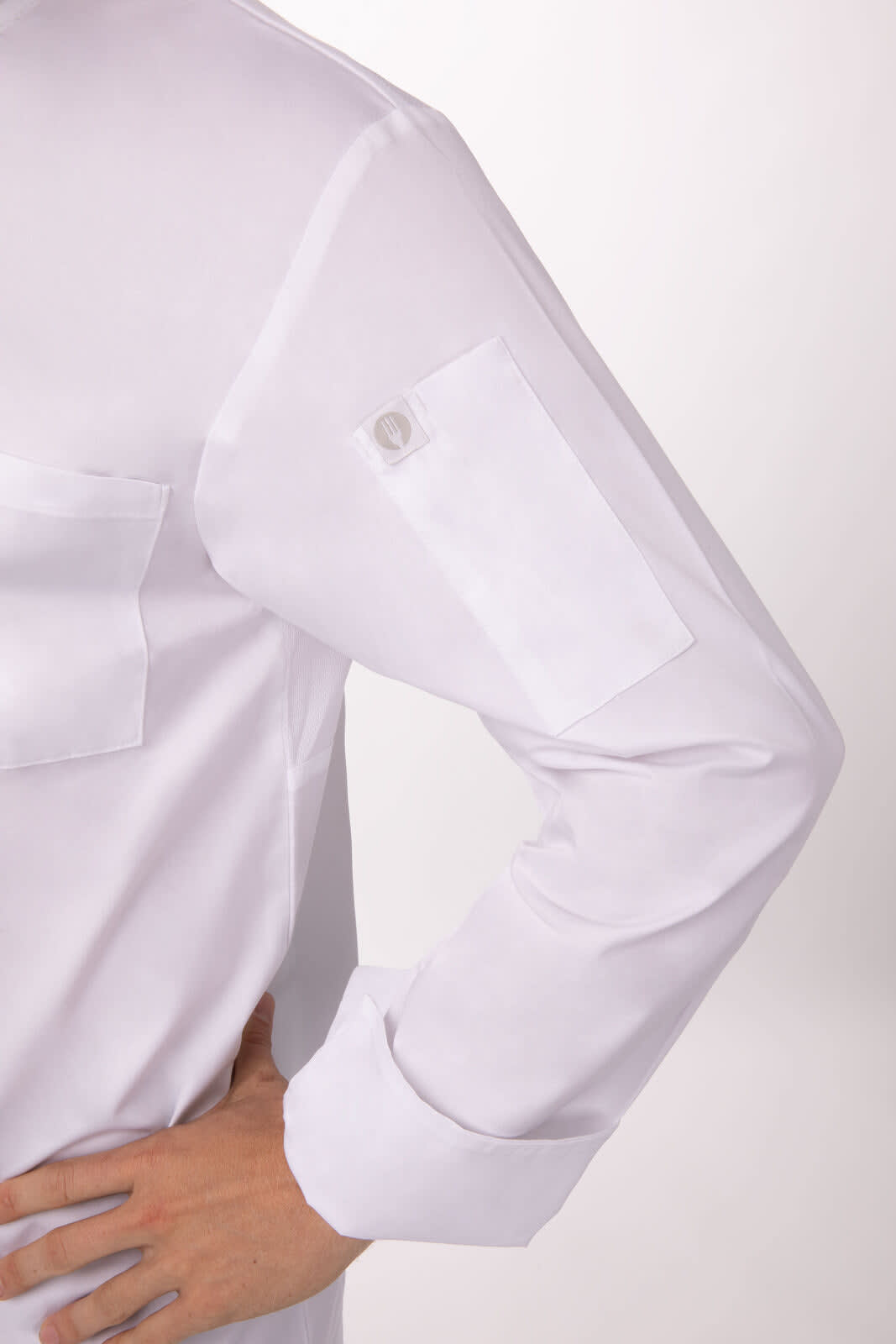 A white chef jacket featuring a pocket on the sleeve and a logo on the upper arm.