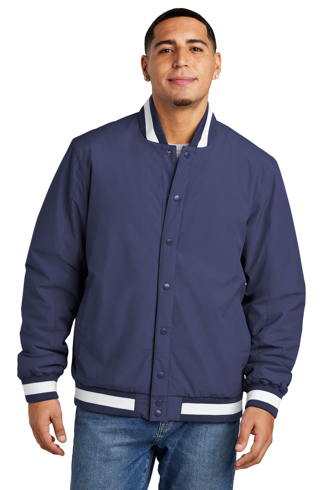 A man wearing a navy insulated varsity jacket with white stripes on the collar and cuffs, featuring a logo.