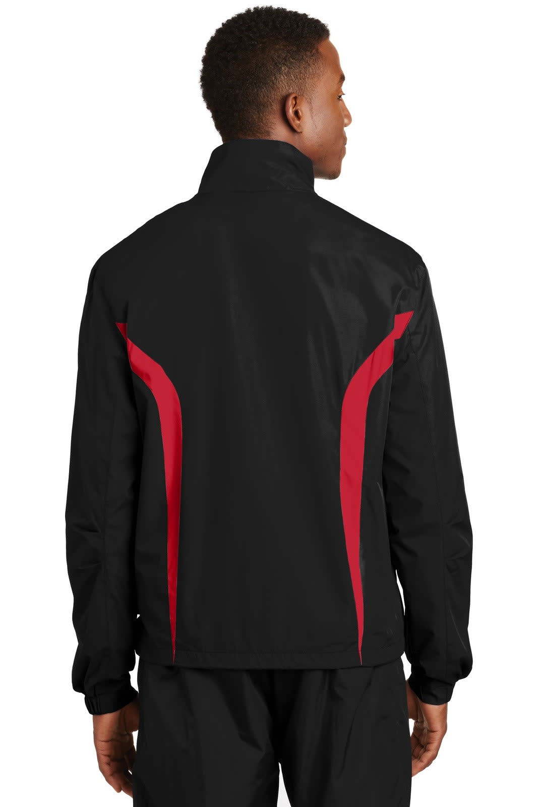 A black and red Sport-Tek Colourblock Raglan Jacket featuring a high collar and a logo on the back.