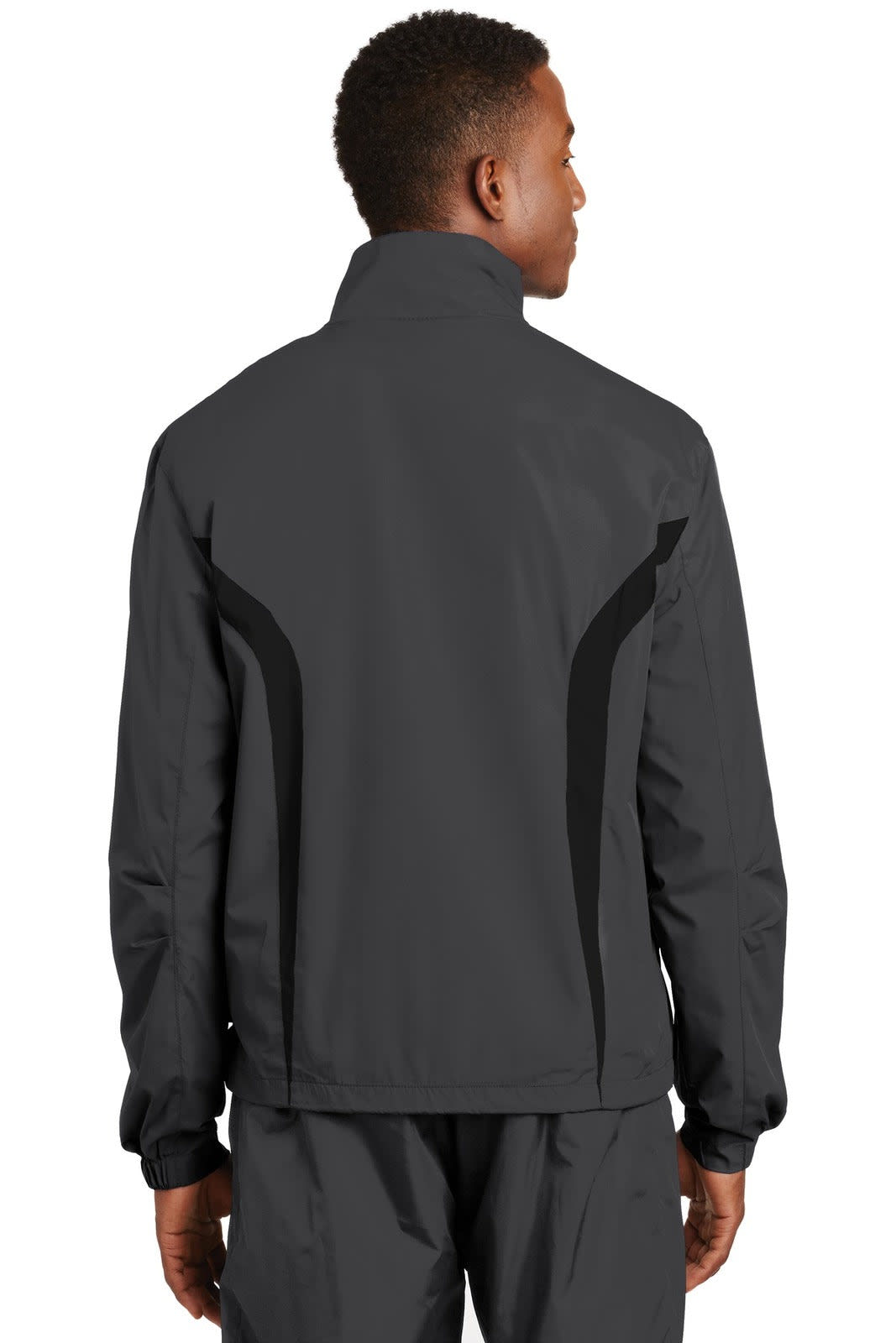 A black Sport-Tek Colorblock Raglan Jacket featuring a stylish design and a logo, viewed from the back.