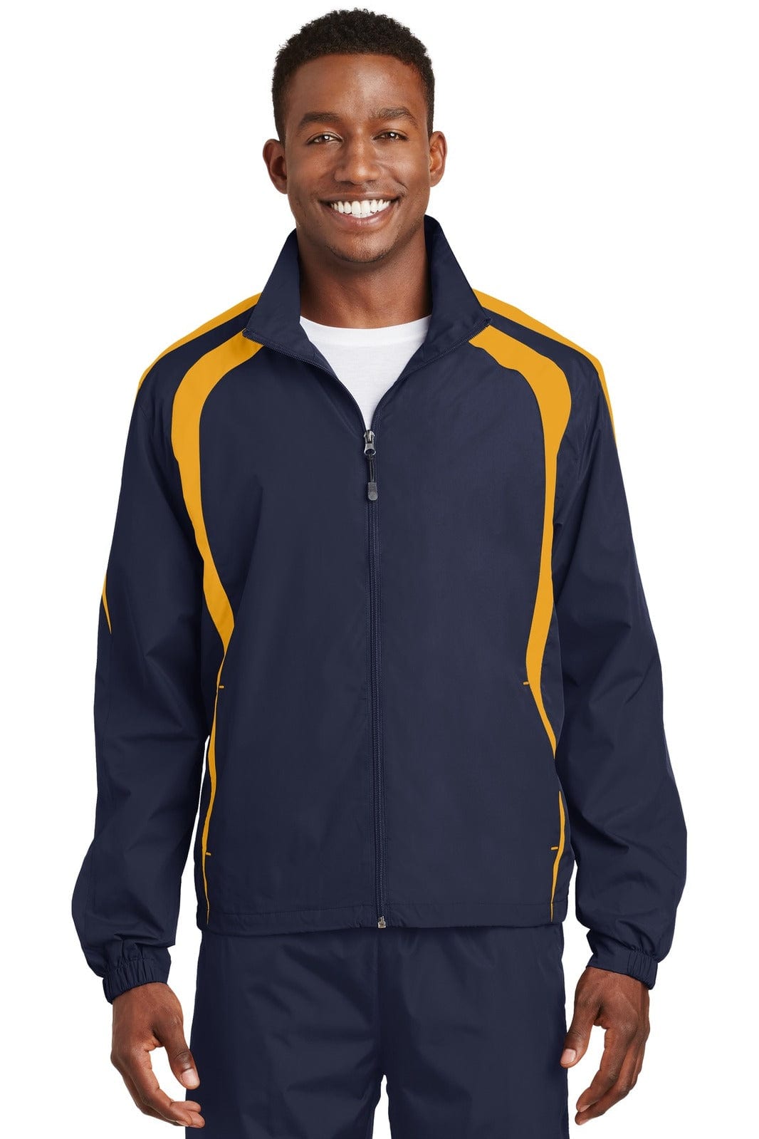 A man wears a navy and yellow Sport-Tek Colorblock Raglan Jacket. The jacket features a zip front and has a logo.