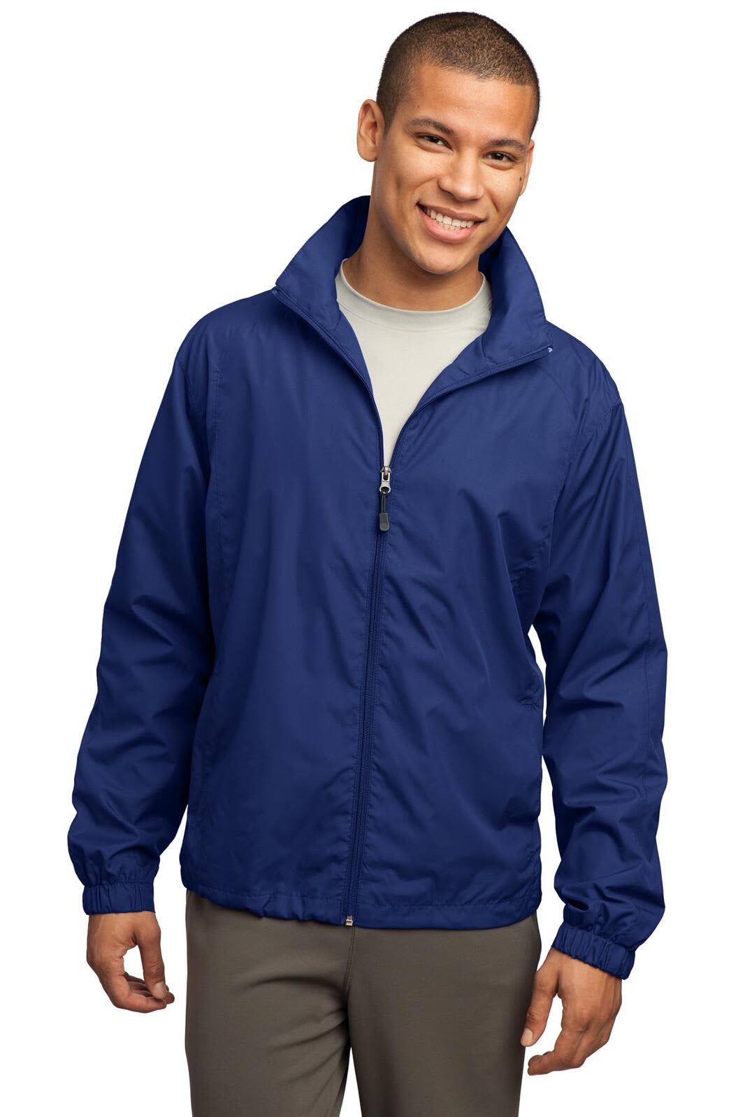 A man wearing a navy blue Sport-Tek full-zip wind jacket with a zippered front and elastic cuffs.