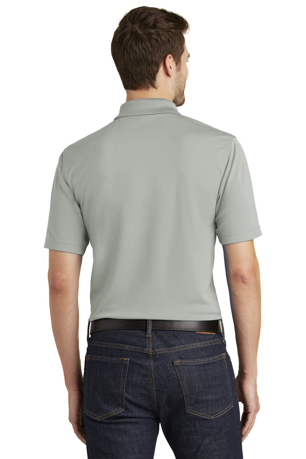 A man wearing a light grey polo shirt, facing away, with jeans and a logo on the back.
