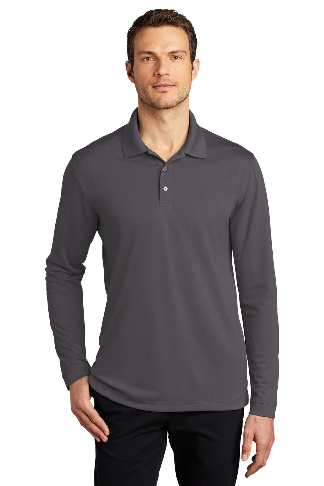 A man wears a long sleeve polo shirt in dark grey, featuring a collar and a logo on the chest.